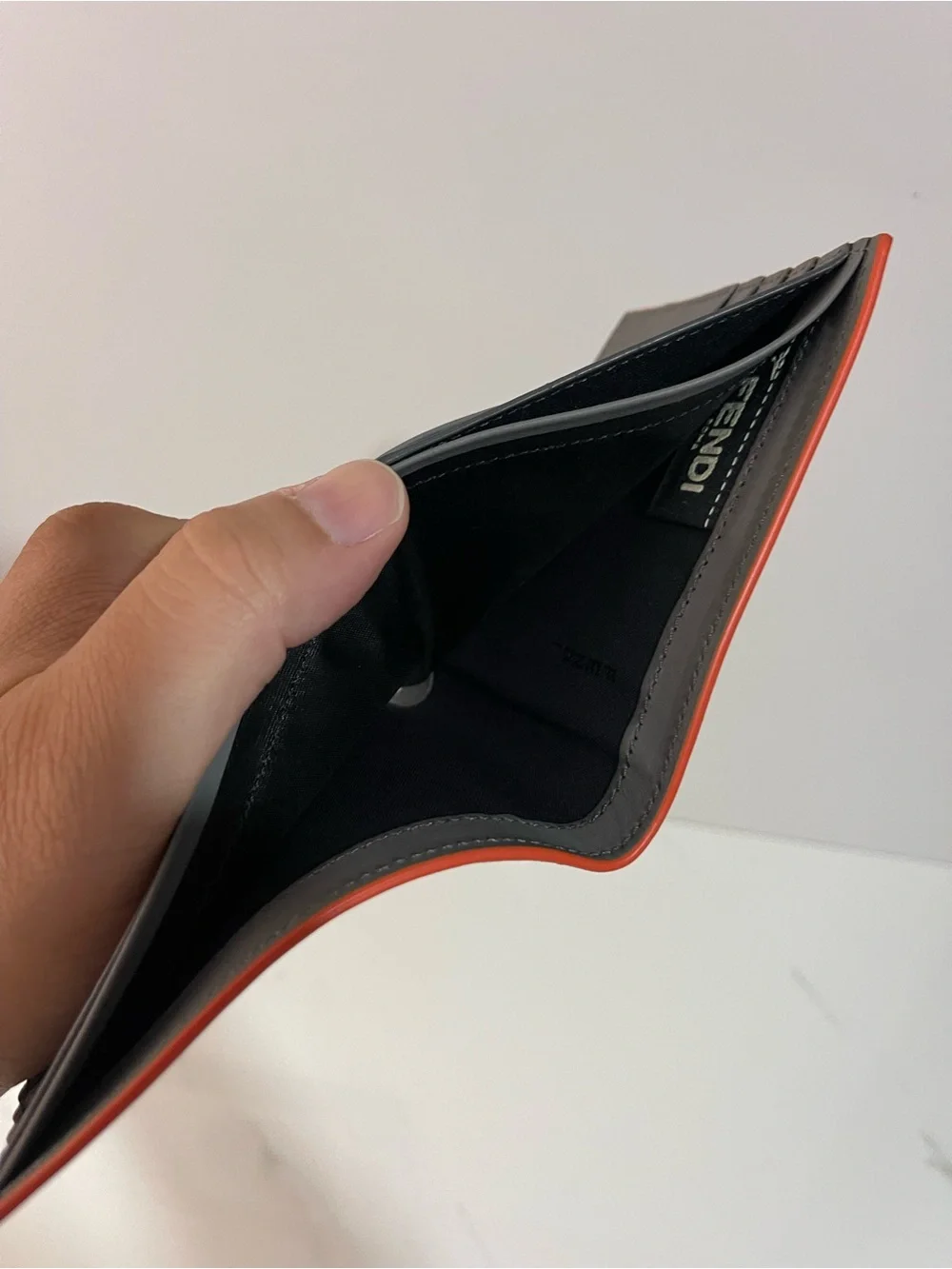 Fendi Gray Leather Embossed Face Bi-Fold Wallet with Orange Trim